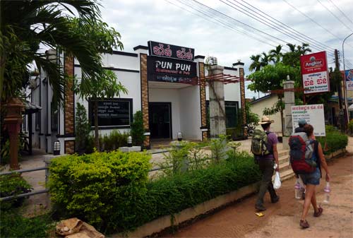 Backpackers walking by a restaurant in Koh Kong
