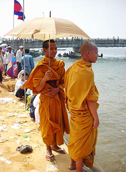 monks watching boat racing in koh kong, cambodia